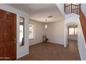 Bright living room with tile flooring, a staircase, and ample natural light at 2527 E Remington Pl, Chandler, AZ 85286
