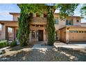Charming two-story home in daylight with a well-manicured front yard and stone accents on the entrance at 2541 E Carob Dr, Gilbert, AZ 85298