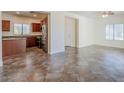 Open-concept living area with tile flooring, neutral walls, and ample natural light from the windows at 26505 N Babbling Brook Dr, Phoenix, AZ 85083