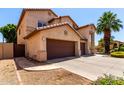 Side view of a two story home with a three car garage and a wooden gate at 2741 E San Tan St, Chandler, AZ 85225