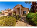 Two story home with desert landscaping, mature palm tree and front entry walkway at 2741 E San Tan St, Chandler, AZ 85225