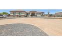 Well-maintained single-story home with neutral paint, rock accents, and desert landscaping at 28156 N Edwards Rd, San Tan Valley, AZ 85143