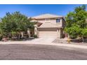 Inviting home with a two-car garage and desert landscaping under a clear blue sky at 28806 N 23Rd Ln, Phoenix, AZ 85085