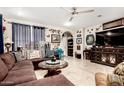 Inviting living room with stylish decor, tile flooring, a ceiling fan, and a comfortable sectional sofa at 2944 N Brighton --, Mesa, AZ 85207