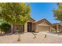 Attractive single-level home featuring desert landscaping, a two-car garage, and well-maintained yard at 29919 N Little Leaf Dr, San Tan Valley, AZ 85143