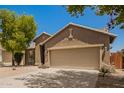 Home exterior with a two-car garage, desert landscaping, and a well-maintained front yard at 29919 N Little Leaf Dr, San Tan Valley, AZ 85143
