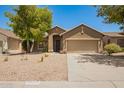 Beautiful home with desert landscaping, spacious driveway, and a two-car garage in a residential neighborhood at 29919 N Little Leaf Dr, San Tan Valley, AZ 85143