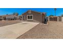 Image of a single story home that includes a desert landscape and a concrete driveway at 3056 N 68Th Ln, Phoenix, AZ 85033