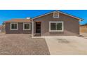Charming single-story home with a desert landscape, covered entry, and a neutral-colored exterior at 3056 N 68Th Ln, Phoenix, AZ 85033