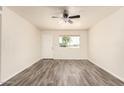 Bright and airy empty room with a large window for natural light and new modern flooring at 3114 W Villa Maria Dr, Phoenix, AZ 85053