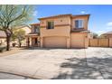 Two-story home featuring a three-car garage and a desert-landscaped front yard under a sunny blue sky at 3423 E Superior Rd, San Tan Valley, AZ 85143