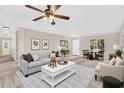 Bright living room with ceiling fan, dining area, and neutral decor at 3423 E Superior Rd, San Tan Valley, AZ 85143