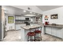 Well-lit kitchen with white cabinets, granite countertops, a mosaic backsplash, and stainless steel appliances, creating a modern space at 4013 E Delta Cir, Mesa, AZ 85206