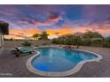 Serene backyard oasis with a sparkling pool, hot tub, and lush landscaping, offering a tranquil retreat at 42161 N Via Cienna --, San Tan Valley, AZ 85140