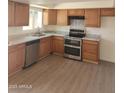 Bright kitchen with stainless steel appliances, granite countertops, and wood-look flooring at 4533 N 17Th Ave, Phoenix, AZ 85015