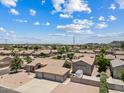 Aerial view of a single-story home with a three-car garage and a detached garage nestled in a residential community at 4701 W Fallen Leaf Ln, Glendale, AZ 85310