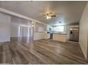 View of a bright, open living space with new wood floors, blending seamlessly into the updated kitchen at 4911 W Merrell St, Phoenix, AZ 85031