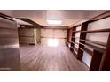 Spacious finished basement with built-in shelves, tile flooring, and ample lighting at 498 W Gail Dr, Chandler, AZ 85225