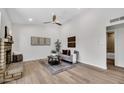 Bright living room with vaulted ceilings, wood floors, a decorative fireplace, and neutral decor at 6415 S Newberry Rd # A, Tempe, AZ 85283