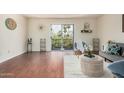 A bright living room features a large sliding glass door, wood floors and neutral decor at 740 W Elm St # 266, Phoenix, AZ 85013