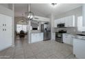 Spacious kitchen with stainless steel appliances, granite countertops, and ample cabinet space at 839 W Silver Creek Rd, Gilbert, AZ 85233