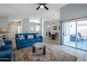 Open-concept living room featuring a ceiling fan, tile floors, and a view to dining at 839 W Silver Creek Rd, Gilbert, AZ 85233