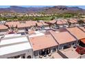 An aerial view of a townhome community featuring landscaped yards and mountain views at 8785 E Greenview Dr, Gold Canyon, AZ 85118