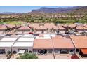 Enjoy the view of this townhome community featuring mature landscaping and red tile roofs at 8785 E Greenview Dr, Gold Canyon, AZ 85118