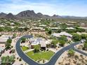 Breathtaking aerial image of the community with desert landscaping, mountain views, and winding roads at 9693 N 129Th Pl, Scottsdale, AZ 85259