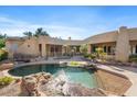 Backyard oasis with a custom pool, spa, and tranquil landscaping perfect for entertaining or relaxation at 9693 N 129Th Pl, Scottsdale, AZ 85259
