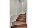 Stylish staircase featuring rich, dark wood steps and sleek white walls and railing at 101 N 7Th St # 225, Phoenix, AZ 85034
