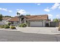 Attractive single-story home with a red tile roof, showcasing a driveway and well-maintained front yard at 1015 E Paradise Ln, Phoenix, AZ 85022