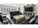 Comfortable living room features a large leather sofa, coffee table, and bright natural light at 1015 E Paradise Ln, Phoenix, AZ 85022