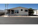 Inviting single-story home featuring a covered carport, landscaped front yard, and decorative exterior accents at 11596 W Sierra Dawn Blvd # 182, Surprise, AZ 85378