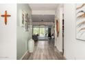 Inviting hallway with hardwood floors, neutral walls, and decorative wall art at 1217 E Monte Way, Phoenix, AZ 85042