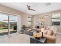 Inviting living room featuring an expansive sectional sofa, and sliding glass doors leading to outdoor patio at 1284 W Sussex St, San Tan Valley, AZ 85143