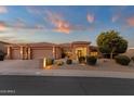 Charming home with well-manicured desert landscaping and warm exterior lighting, perfect for evening curb appeal at 15600 E Robin Dr, Fountain Hills, AZ 85268