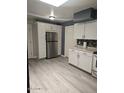 This bright kitchen features stainless appliances, ample storage, and light, wood-look flooring throughout at 2019 E Southern Ave, Phoenix, AZ 85040