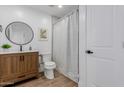 Well-lit bathroom with wood vanity, framed mirror, and a shower tub at 2041 W Palo Verde Dr, Phoenix, AZ 85015