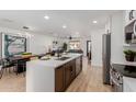 Modern kitchen with stainless steel appliances, white countertops, and a view into the living room at 2041 W Palo Verde Dr, Phoenix, AZ 85015