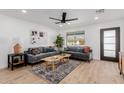 Bright living room featuring comfortable gray sofas, a wooden coffee table, and a decorative rug at 2041 W Palo Verde Dr, Phoenix, AZ 85015