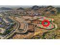 Stunning aerial view of the community nestled in the foothills of the mountains with available lots at 27366 N 69Th Dr, Peoria, AZ 85383