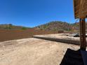 This is the backyard of a new home build with a brick wall and view of the desert mountains at 27366 N 69Th Dr, Peoria, AZ 85383