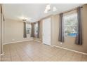 Bright living room with tile flooring, neutral walls, and ample natural light from large windows at 2947 N Evergreen St, Buckeye, AZ 85396