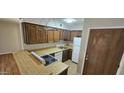 Cozy kitchen with ample cabinet space, white appliances, and laminate countertops at 3131 W Cochise Dr # 256, Phoenix, AZ 85051