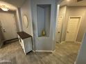 Welcoming entryway with a decorative niche, wood-look tile flooring and view to other rooms at 330 W Evergreen Pear Ave, Queen Creek, AZ 85140