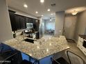 Modern kitchen with granite countertops, stainless steel appliances, and dark cabinets at 330 W Evergreen Pear Ave, Queen Creek, AZ 85140