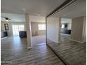 Open-concept living room showcasing wood-look flooring and a view into the kitchen with modern bar seating at 3810 W Yucca St, Phoenix, AZ 85029