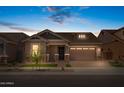 Charming single-story home at dusk with a stone-accented facade, landscaped front yard and an attached two-car garage at 4314 E Bernice St, Gilbert, AZ 85295