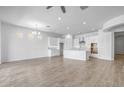 Spacious open-concept design featuring the living and kitchen areas with modern lighting and hardwood floors at 4314 E Bernice St, Gilbert, AZ 85295